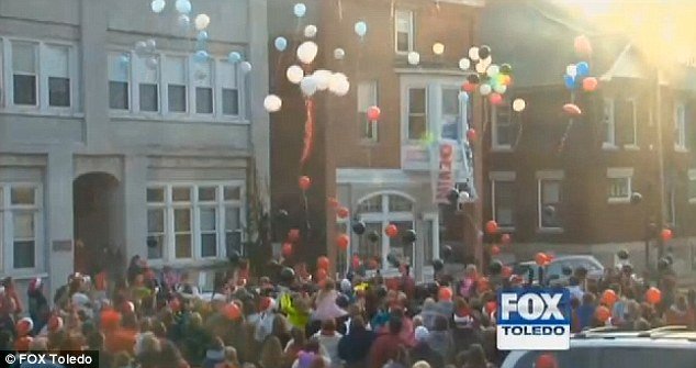 Big turn out: Hundreds of residents wore red and green, sang Christmas carols and decorated their homes with lights for Devin Kohlman