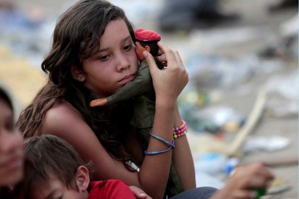 SA supporter of Venezuela's late President Hugo Chavez holds a doll of him in Caracas