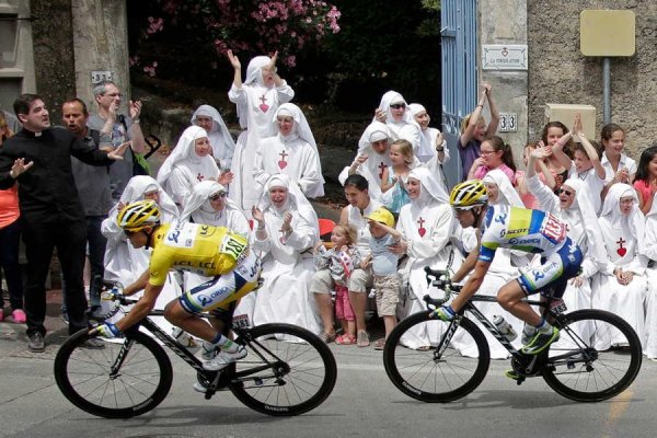 Race leader yellow jersey holder Orica Greenedge team rider Simon Gerrans of Australia cycles past Sisters of the Consolation congregation during the 228.5 km fifth stage of the centenary Tour de France cycling race from Cagnes-Sur-Mer to Marseille