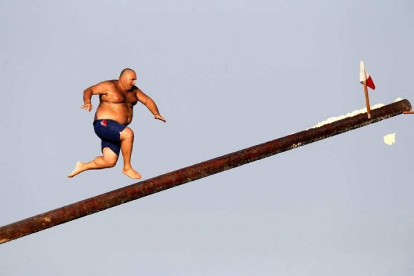 A man runs up the "gostra" during the religious feast of St Julian outside Valletta